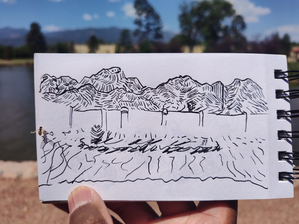black ink drawing of mountains in the distance with a man-made pond in the foreground.